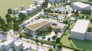 Zijaanzicht van het 't Stroomdalgebied. Vooraan de nieuwe school. Daarachter parkeerplaatsen en zwembad De Peppel.